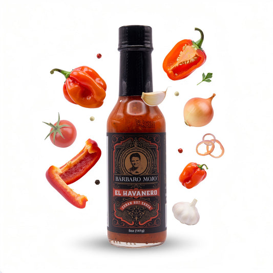 Barbaro Mojo El Havanero bottle surrounded by habaneros, red bell pepper, tomato, onion and garlic