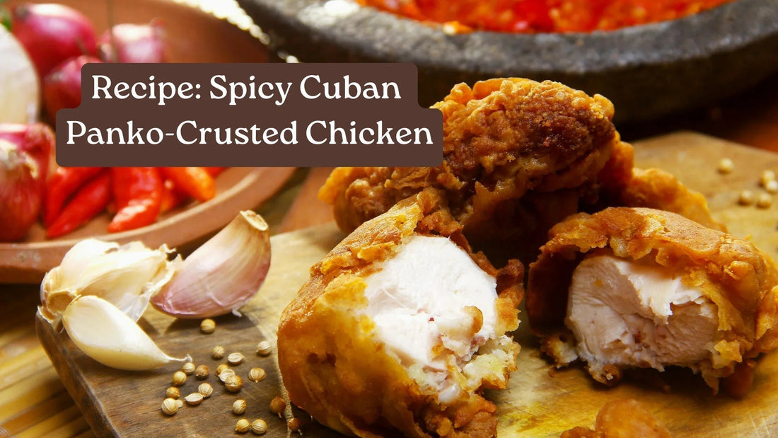 Panko-crusted fried chicken pieces split open to show the juicy center, with garlic cloves and red chiles behind