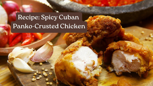 Panko-crusted fried chicken pieces split open to show the juicy center, with garlic cloves and red chiles behind