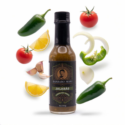 Barbaro Mojo Jalabáo bottle surrounded by jalapeños, green bell pepper, tomato, lemon, onion and garlic