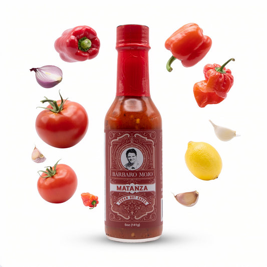 Barbaro Mojo Matanza bottle surrounded by habanero, red bell pepper, tomatoes, onion, lemon and garlic