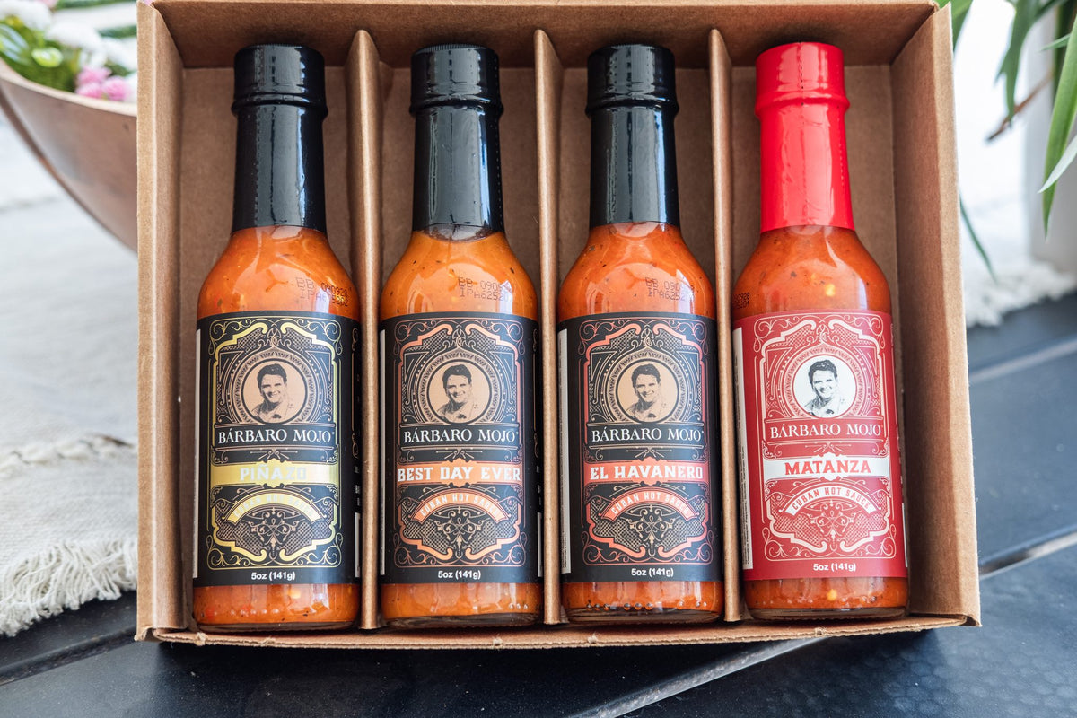 Open kraft gift box with four Barbaro Mojo hot sauces: Piñazo, Best Day Ever, El Havanero and Matanza